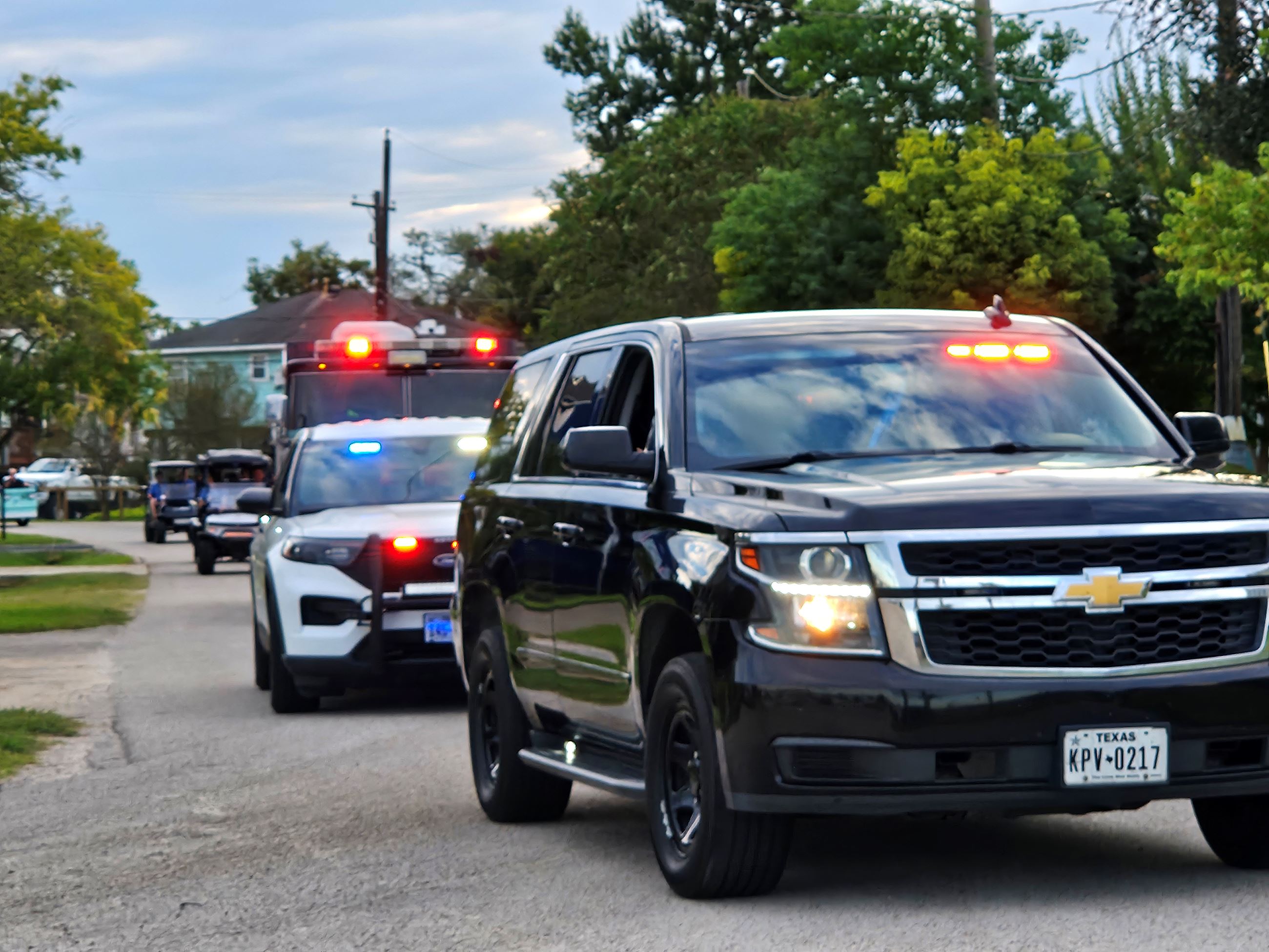Parade of golf carts, police cars and Kemah firetruck